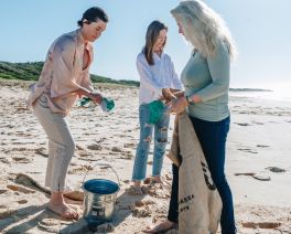 team of take 3 cleaning up a local beach of litter